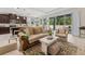 Bright living room with comfortable seating, and a glimpse of the kitchen area, creating a cozy atmosphere at 1237 Windy Bay Shl, Tarpon Springs, FL 34689