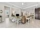 Elegant living room featuring tiled floors, comfortable seating, and a calming neutral color palette at 1237 Windy Bay Shl, Tarpon Springs, FL 34689