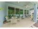 Covered patio area with seating, ceiling fan, and sliding glass doors leading to the home's interior at 1237 Windy Bay Shl, Tarpon Springs, FL 34689