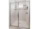 Shower with white tile and brushed nickel fixtures at 1237 Windy Bay Shl, Tarpon Springs, FL 34689