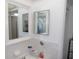 Bright bathroom featuring white tiled walls, decorative accents, and a large mirror at 1250 S Pinellas Ave # 1013, Tarpon Springs, FL 34689