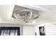 A close up shot of the ceiling and a brushed metal cage ceiling fan with light fixtures at 1250 S Pinellas Ave # 1013, Tarpon Springs, FL 34689