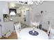 Bright dining area flowing into a kitchen with white cabinets, appliances and decor at 1250 S Pinellas Ave # 1013, Tarpon Springs, FL 34689