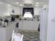 Bright kitchen with sleek white cabinets, modern appliances, granite countertops, and stylish backsplash at 1250 S Pinellas Ave # 1013, Tarpon Springs, FL 34689
