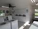 Clean laundry room featuring rows of washers and dryers, tile flooring, and outside access at 1250 S Pinellas Ave # 1013, Tarpon Springs, FL 34689