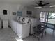 Community laundry room with multiple washers, cart, folding table and bright lighting at 1250 S Pinellas Ave # 1013, Tarpon Springs, FL 34689