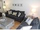 Cozy living room featuring hardwood floors, comfortable sofas, and nautical themed decor at 1250 S Pinellas Ave # 1013, Tarpon Springs, FL 34689