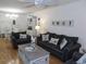 Living room boasts hardwood floors, comfortable sofas, and charming nautical decor at 1250 S Pinellas Ave # 1013, Tarpon Springs, FL 34689