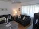 Cozy living room with comfortable sofas, hardwood floors, and bright natural light at 1250 S Pinellas Ave # 1013, Tarpon Springs, FL 34689