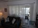Bright living room space filled with natural light and comfortable furniture at 1250 S Pinellas Ave # 1013, Tarpon Springs, FL 34689