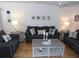 Charming living room featuring hardwood floors, comfortable sofas, and lovely nautical decor at 1250 S Pinellas Ave # 1013, Tarpon Springs, FL 34689