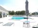 Community pool with pristine deck, lounge chairs, and convenient lounge area at 1250 S Pinellas Ave # 1013, Tarpon Springs, FL 34689