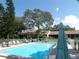 Community pool surrounded by lush landscaping and seating areas at 1250 S Pinellas Ave # 1013, Tarpon Springs, FL 34689