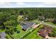 Aerial view of the property showcasing the home, pool, and lush surroundings in a residential neighborhood at 126 Holly Tree Ln, Brandon, FL 33511