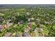 Beautiful aerial view of a single-Gathering home in a quiet neighborhood, surrounded by mature trees and well-manicured lawns at 126 Holly Tree Ln, Brandon, FL 33511