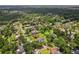 Expansive aerial view showcasing the home's location within a lush, green residential neighborhood with mature trees at 126 Holly Tree Ln, Brandon, FL 33511