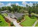 Aerial view featuring the home, expansive yard, mature trees, driveway and the surrounding neighborhood at 126 Holly Tree Ln, Brandon, FL 33511