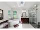 Luxurious bathroom featuring a soaking tub, modern fixtures, and a glass-enclosed shower at 126 Holly Tree Ln, Brandon, FL 33511