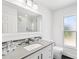 Clean bathroom with white vanity, modern fixtures, and natural light from the window at 126 Holly Tree Ln, Brandon, FL 33511