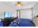 Bright bedroom with a ceiling fan, a large wardrobe, and beach views on television at 126 Holly Tree Ln, Brandon, FL 33511
