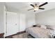 Cozy bedroom with a ceiling fan, closet, and comfortable bed with decorative pillows at 126 Holly Tree Ln, Brandon, FL 33511