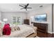 Bright bedroom showcasing modern ceiling fan, hardwood floors, and exterior access at 126 Holly Tree Ln, Brandon, FL 33511
