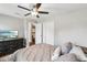 Bedroom with a ceiling fan, closet, TV, and comfortable bed with decorative pillows at 126 Holly Tree Ln, Brandon, FL 33511