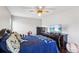 Charming bedroom featuring a ceiling fan, mounted television, and dark wood furnishings at 126 Holly Tree Ln, Brandon, FL 33511