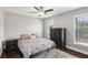Comfortable bedroom with a ceiling fan, windows, and a bed with throw pillows at 126 Holly Tree Ln, Brandon, FL 33511