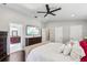 Spacious bedroom with a modern ceiling fan, adjacent bathroom, and neutral walls at 126 Holly Tree Ln, Brandon, FL 33511