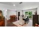 Elegant dining space showcasing hardwood floors and natural light, with a view of lush greenery and an inviting ambiance at 126 Holly Tree Ln, Brandon, FL 33511