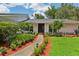 Inviting front entrance with a paved walkway, lush landscaping, and modern architectural details at 126 Holly Tree Ln, Brandon, FL 33511
