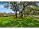 Beautiful home exterior with lush front yard, mature trees, and inviting curb appeal at 126 Holly Tree Ln, Brandon, FL 33511