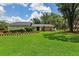 Beautifully landscaped front yard with lush green lawn and manicured hedges and flowerbeds enhance this home's curb appeal at 126 Holly Tree Ln, Brandon, FL 33511