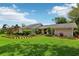 Landscaped front yard with vibrant flowerbeds and lush lawn enhances the curb appeal of this well-maintained home at 126 Holly Tree Ln, Brandon, FL 33511