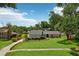 Attractive home featuring meticulous landscaping, a stone-lined flower bed, and a lush, green lawn at 126 Holly Tree Ln, Brandon, FL 33511