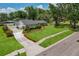 Charming home showcasing a well-maintained lawn, mature trees, and a neatly paved driveway at 126 Holly Tree Ln, Brandon, FL 33511