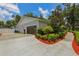 Exterior view of the home featuring a garage, driveway, and well-maintained landscaping at 126 Holly Tree Ln, Brandon, FL 33511
