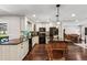 Bright kitchen features granite counters, wooden floors, and stainless steel appliances at 126 Holly Tree Ln, Brandon, FL 33511