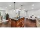 Open kitchen with center island, dark granite counters, and hardwood flooring at 126 Holly Tree Ln, Brandon, FL 33511