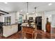 Beautiful kitchen with black appliances, granite countertop island, and hardwood floors, offering a stylish cooking space at 126 Holly Tree Ln, Brandon, FL 33511