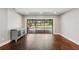 Bright living room featuring beautiful dark wood floors and a sliding glass door, providing easy access to outdoor pool area at 126 Holly Tree Ln, Brandon, FL 33511