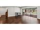 Open-concept living room featuring dark wood floors and sliding doors to the pool for seamless indoor/outdoor living at 126 Holly Tree Ln, Brandon, FL 33511