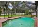 A screened-in pool, surrounded by brick pavers, offering a private retreat with a beautiful backyard view at 126 Holly Tree Ln, Brandon, FL 33511