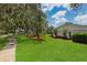 Spacious lawn with mature trees and attractive landscaping creates a serene outdoor environment at 126 Holly Tree Ln, Brandon, FL 33511