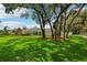 Lush green lawn with mature trees and decorative landscaping enhances the curb appeal of this inviting home at 126 Holly Tree Ln, Brandon, FL 33511