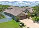 Stunning aerial view of a single-story home featuring a large roof, spacious driveway, and a well-kept yard at 12801 Stanwyck Cir, Tampa, FL 33626
