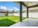 Backyard featuring lush green grass, a patio, a well-maintained fence, and a blue sky backdrop at 12801 Stanwyck Cir, Tampa, FL 33626