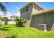Spacious backyard with lush grass, showcasing the house exterior and a well-maintained lawn at 12801 Stanwyck Cir, Tampa, FL 33626