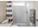 Bright bathroom featuring a tiled shower, shower curtain, and a towel bar with decorative towel at 12801 Stanwyck Cir, Tampa, FL 33626